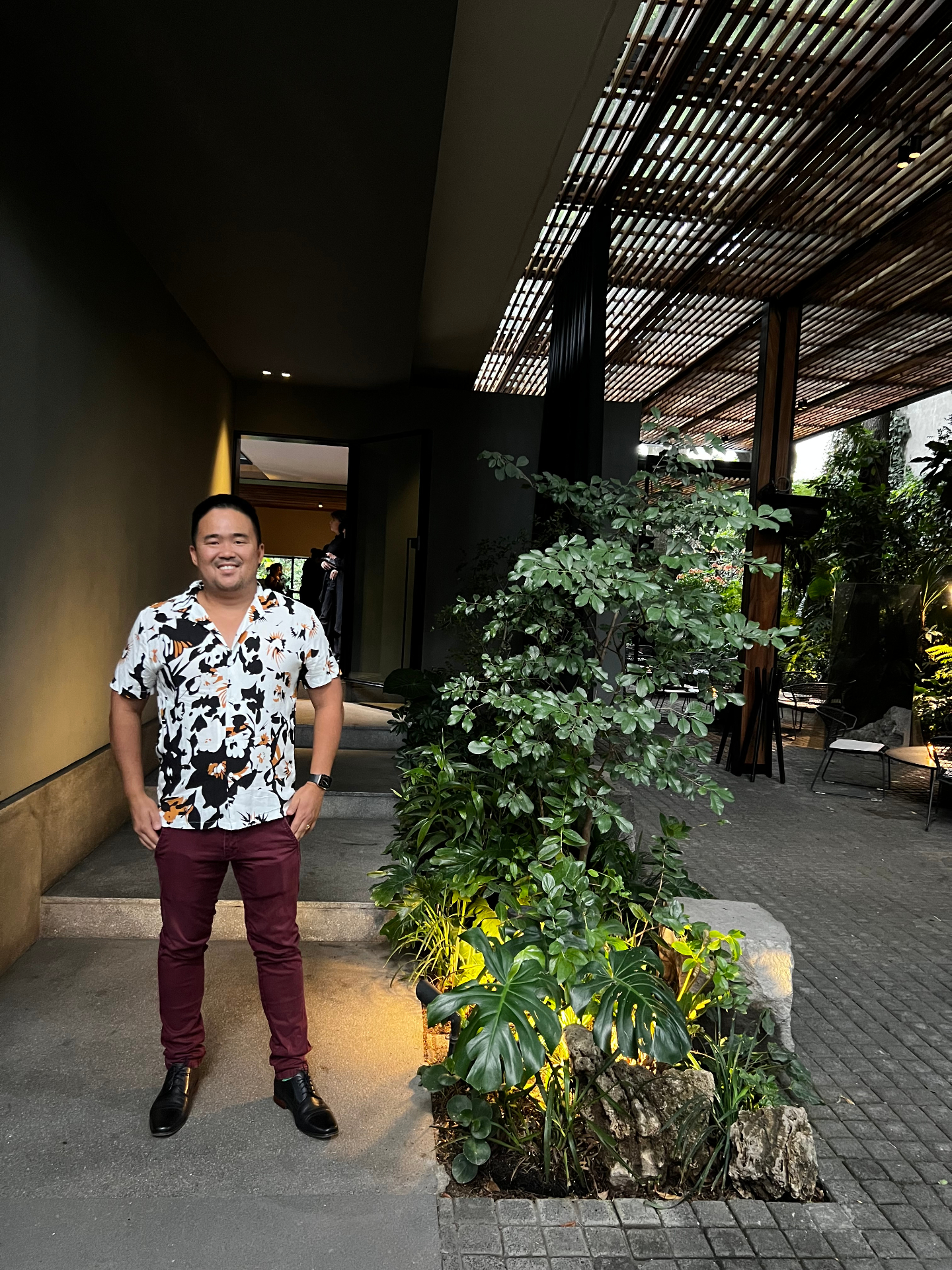 Jon Tran at a restaurant entrance